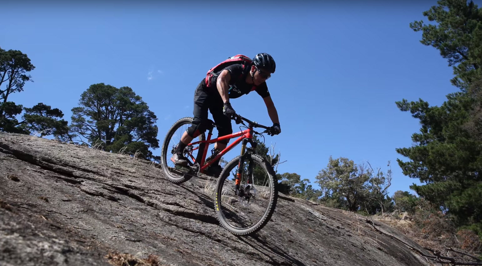Rider takes on a granite slope at the Harcourt Mountain Bike Park